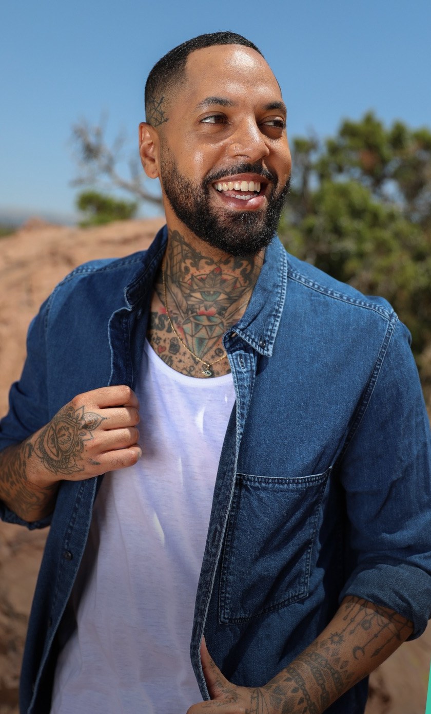 A smiling man in a denim shirt, shown as a Surge profile